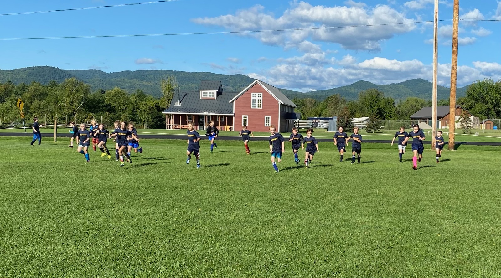 Soccer team racing across a field