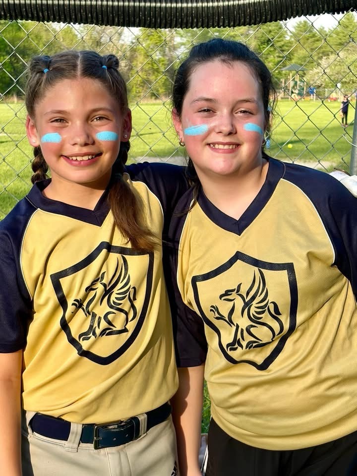 2 Softball girls posing