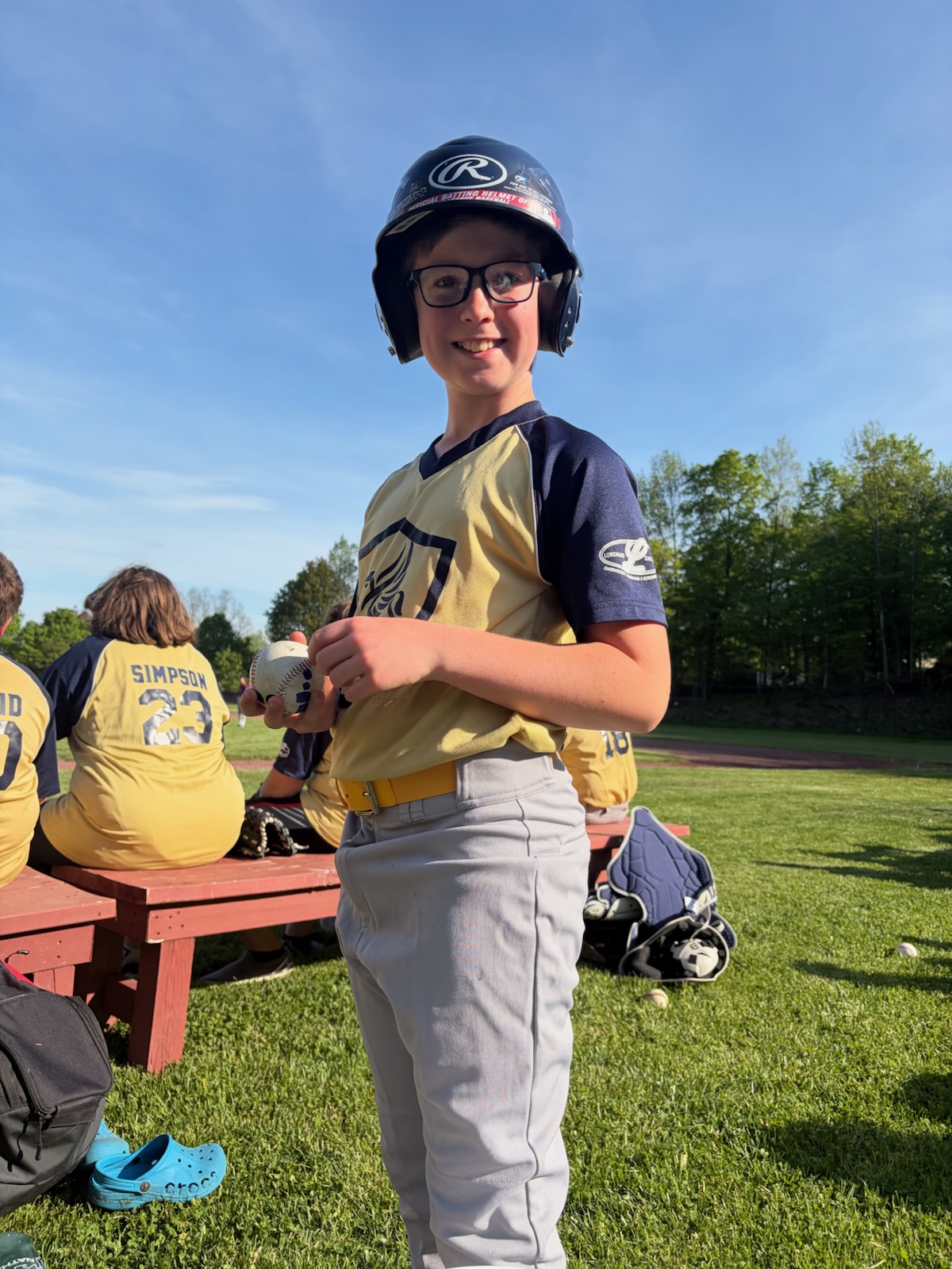 Boy smiling getting ready to play baseball