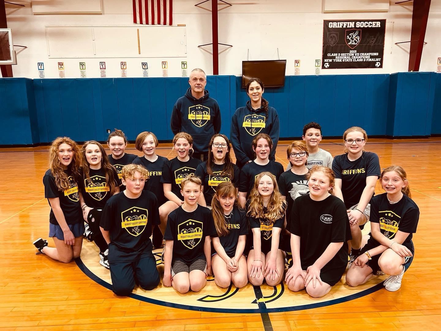 Youth Basketball Team posing together with their coaches