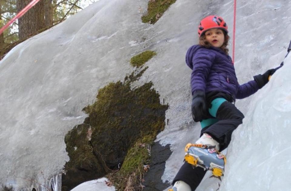 Teen girl ice climbing