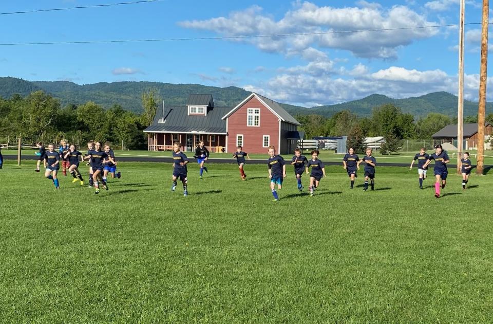 Soccer team racing across a field