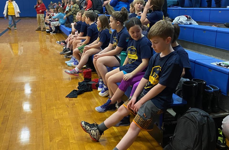 Kids on a basketball bench