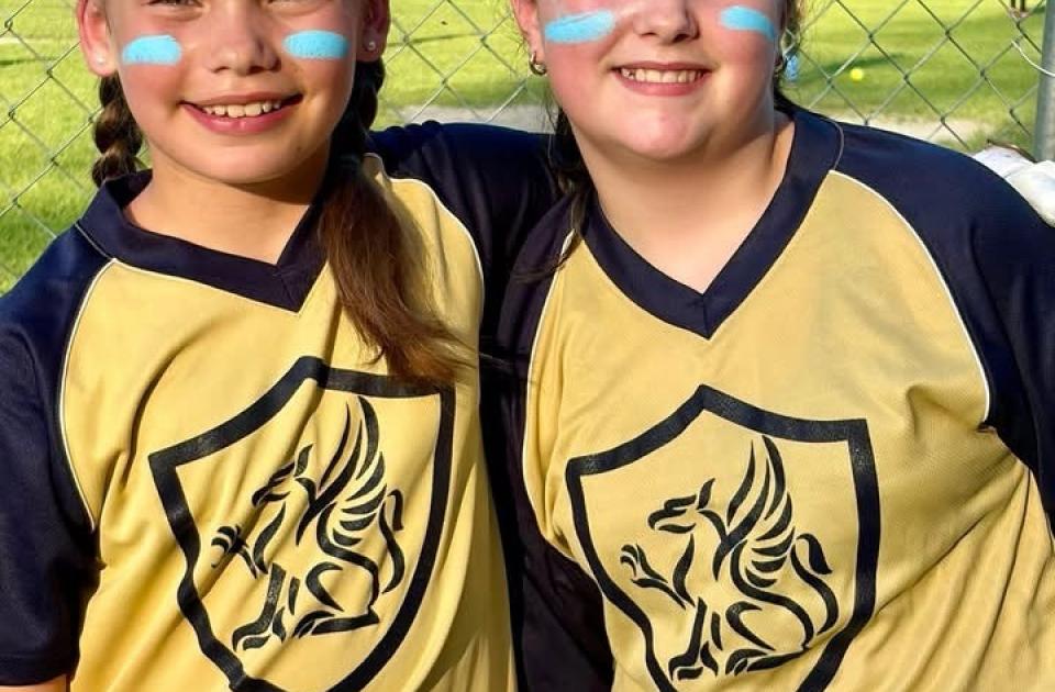 2 Softball girls posing