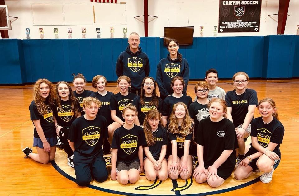 Youth Basketball Team posing together with their coaches